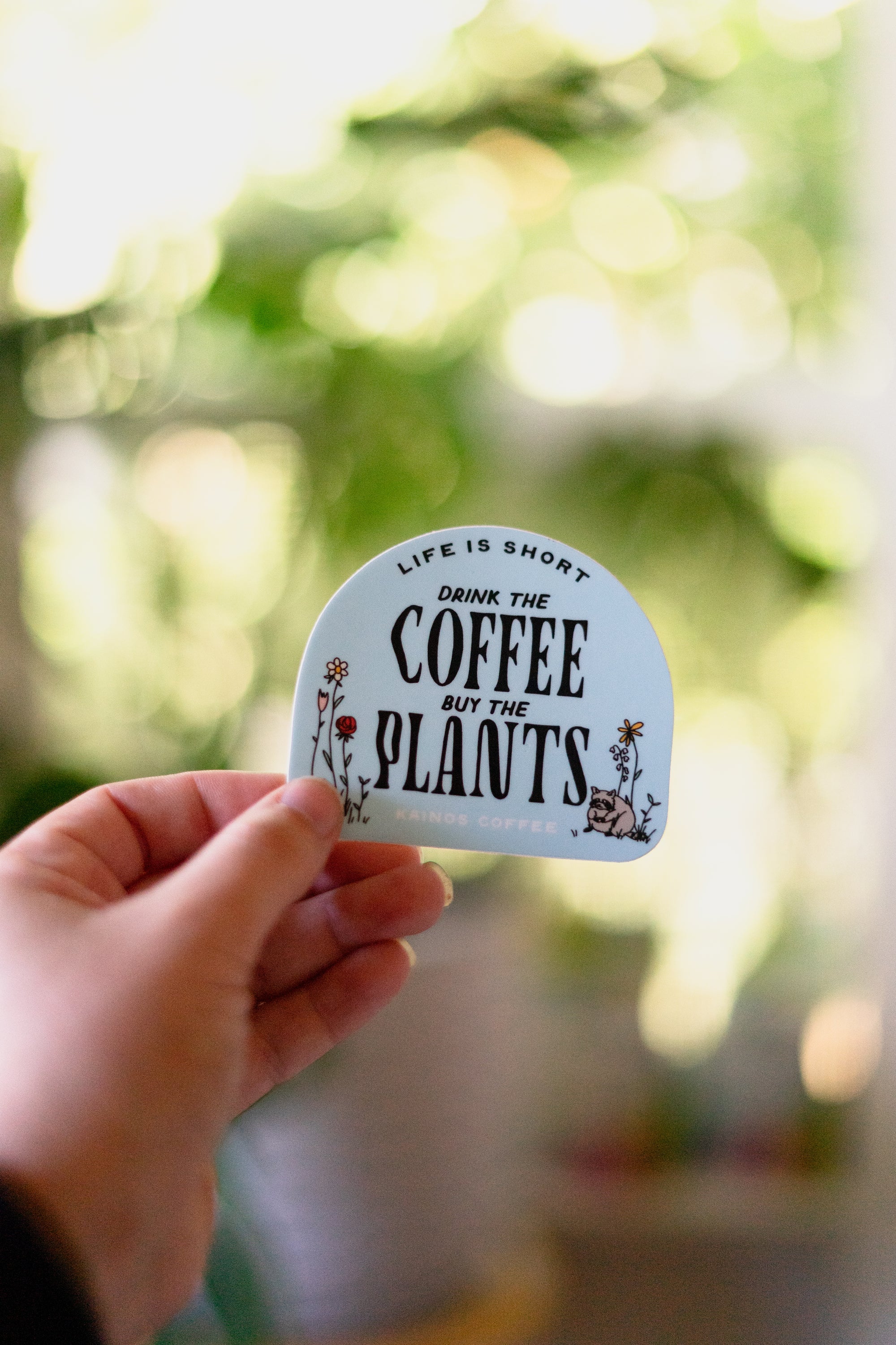 Drink the coffee, Buy the plants raccoon sticker